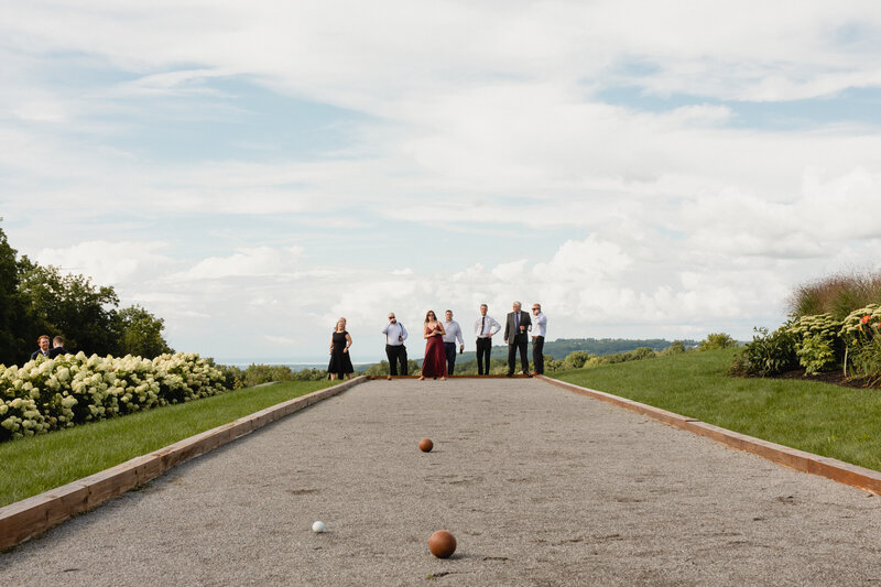 wedding guests playing bocce at wedding weekend venue in Upstate New York