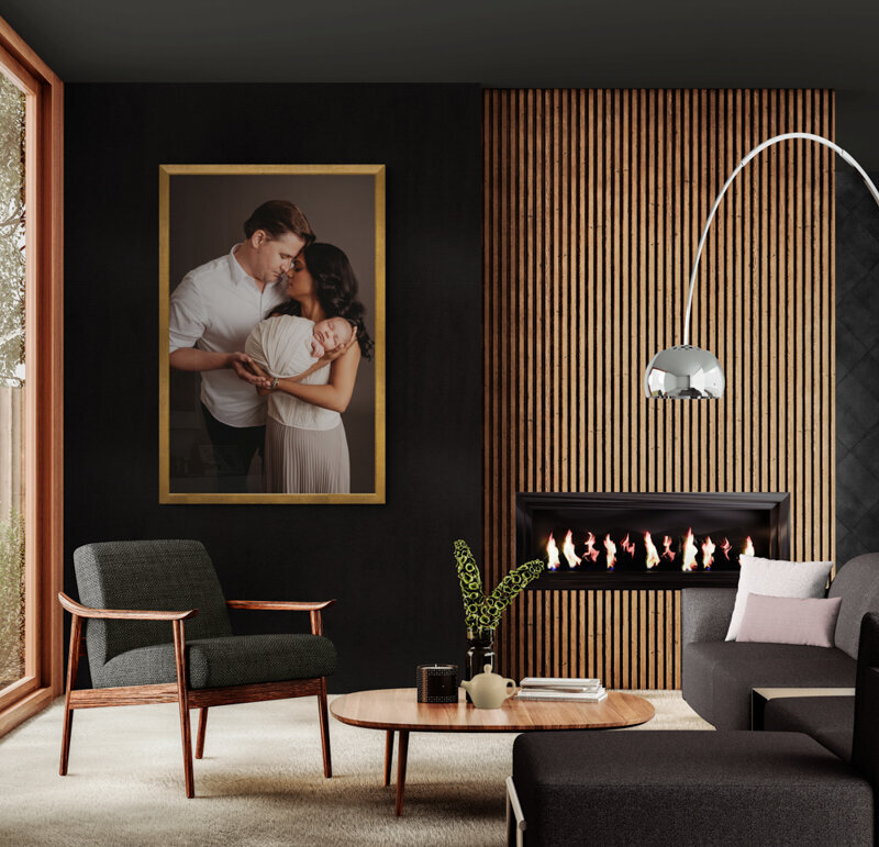 high end family room with black walls and fluted fireplace wall with very large piece of artwork on the wall from newborn portrait session.