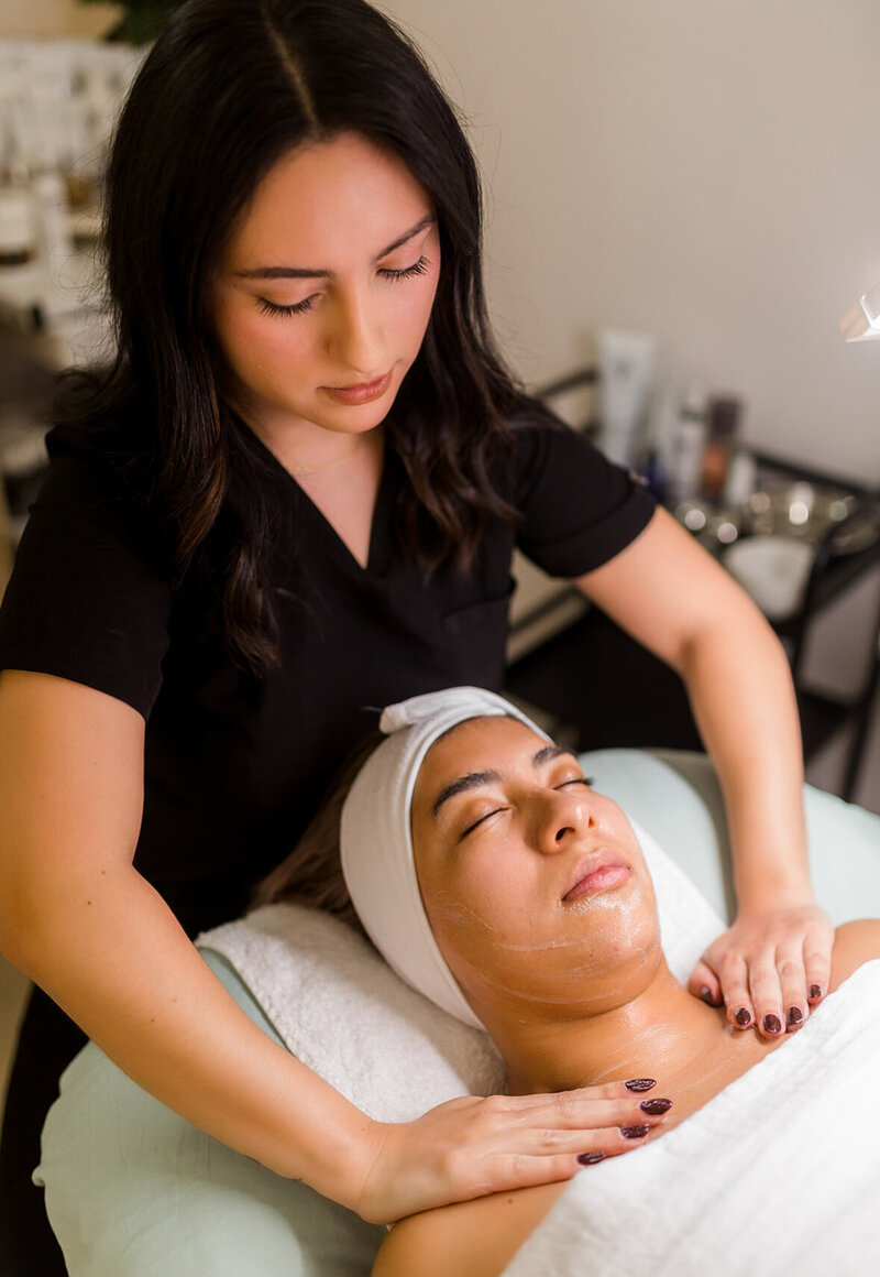 Northwest Arkansas esthetician giving massage with facial
