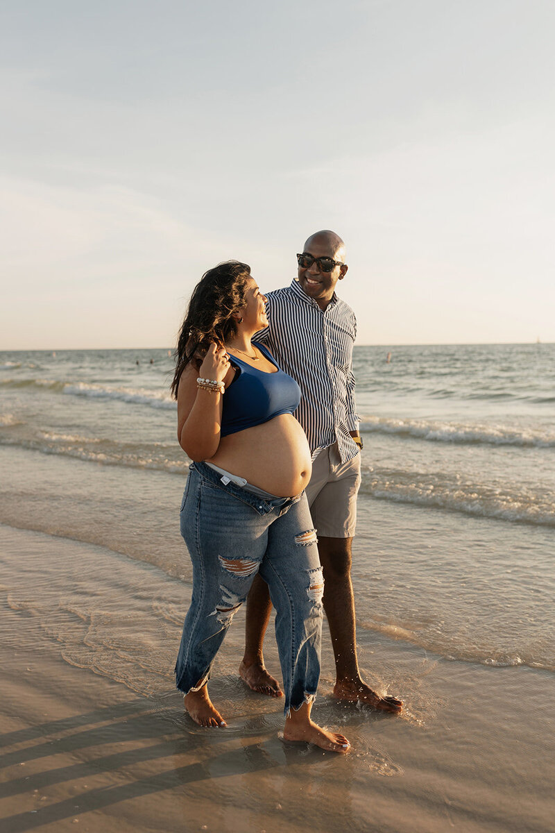 gainesville fl maternity photos on beach mom and dad embracing each other