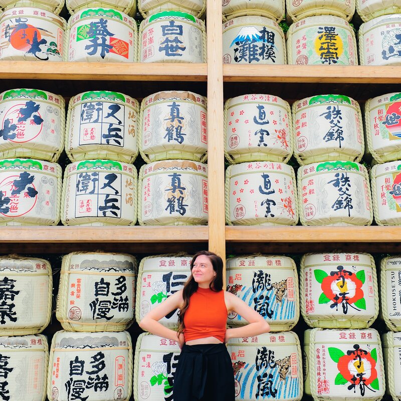 kacy beck in front of barrels in japan