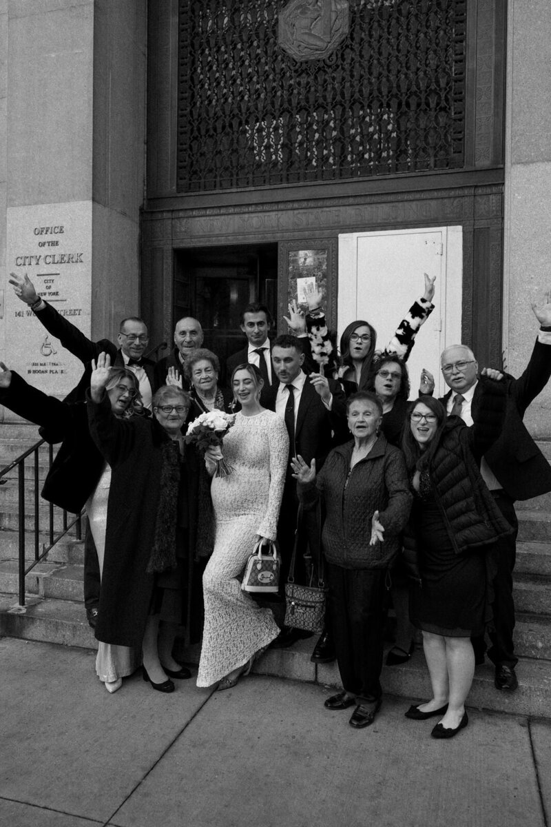 Bride and groom celebrating after their Manhattan city hall ceremony in New York City, NY with their family, by Andrea-Marie Photography