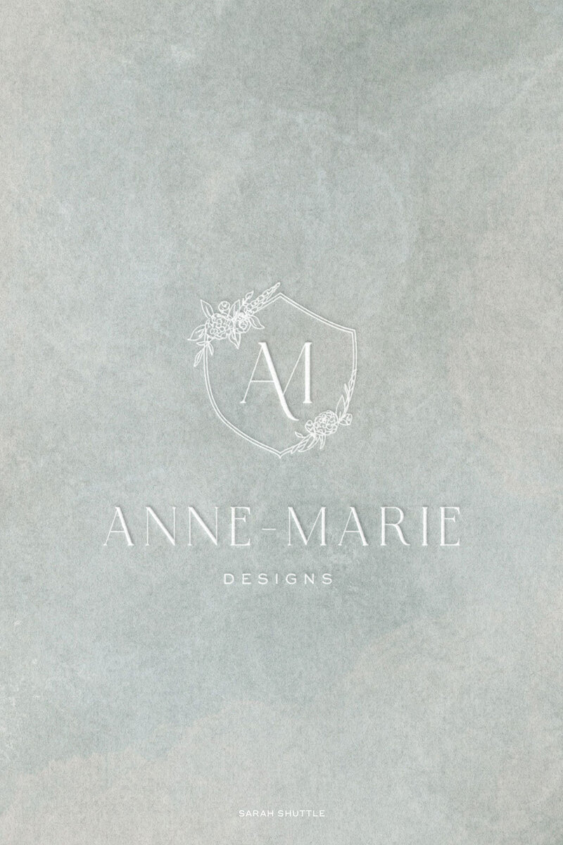 Main logo with floral crest and monogram on soft painted background