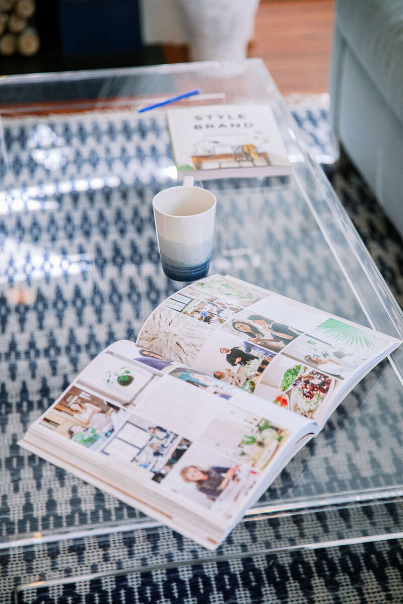 Showit website mocked up on a mobile phone on a clear coffee table surrounded by brand inspiration photos