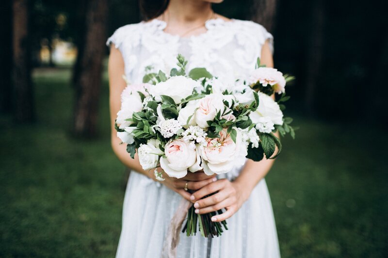 Bride holding white and blush bouquet