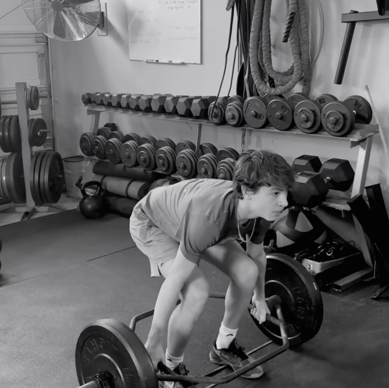 Young athlete is working out at Silverback Fitness, Sarnia's best personal training gym for young athletes and teens. He is being coached by Sarnia's best personal trainer Jim Stewart