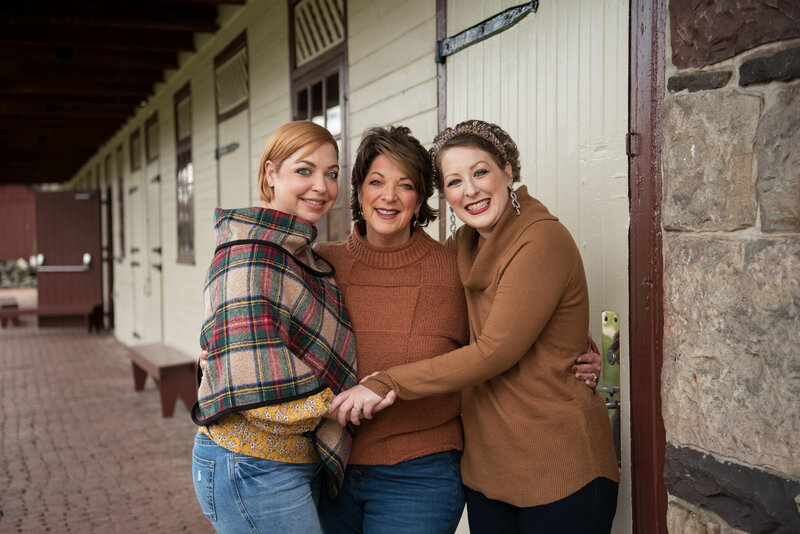 Mom and two adult daughters, barn, autumn colors
