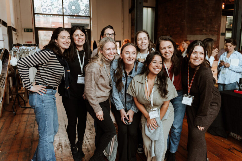Woman posing whilst attendees photography her