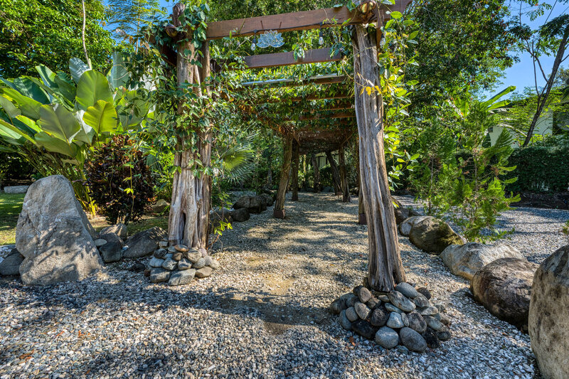 an arch way of tress on the grounds of the retreat center in costa rica 