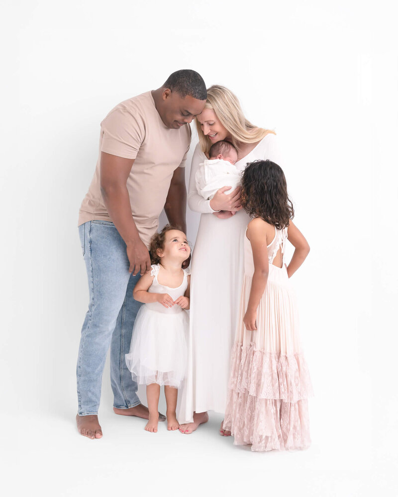 adorable family portrait in downtown mckinney against interesting wall