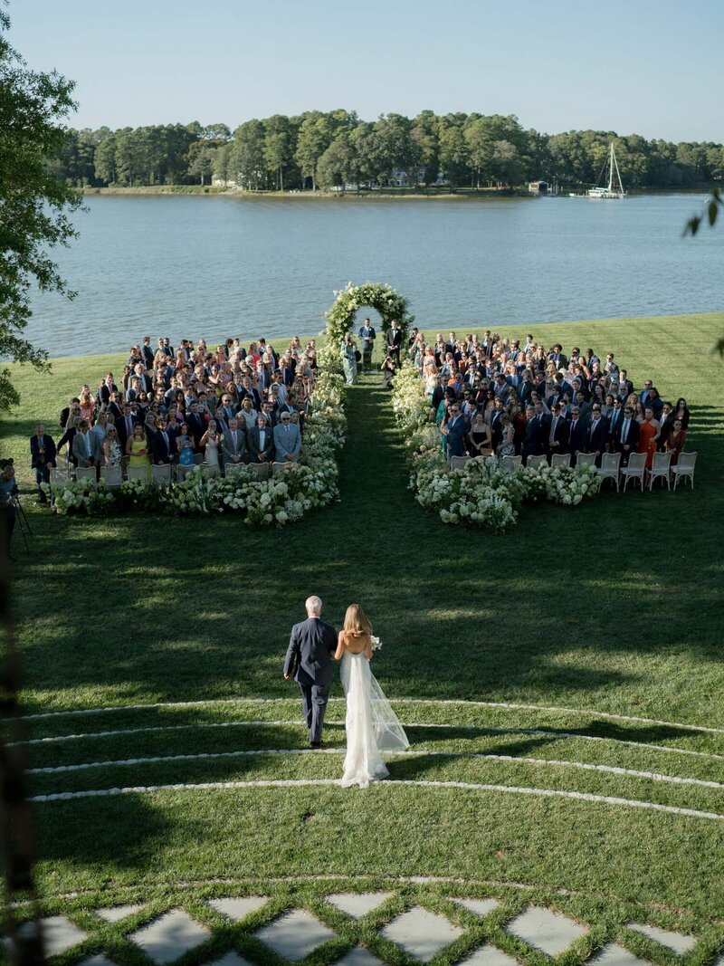 Bride walking down the aisle with her father during wedding ceremony