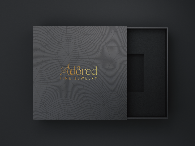 Adored Gold Logo on Black Box