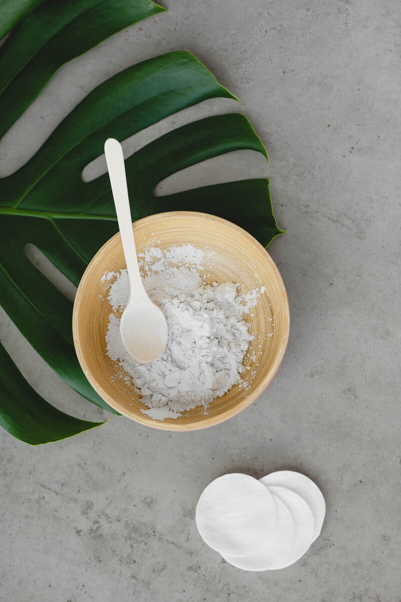 Skincare ingredients in a bowl with palm leaf, St. Pete Rejuvenate Aesthetic Treatment