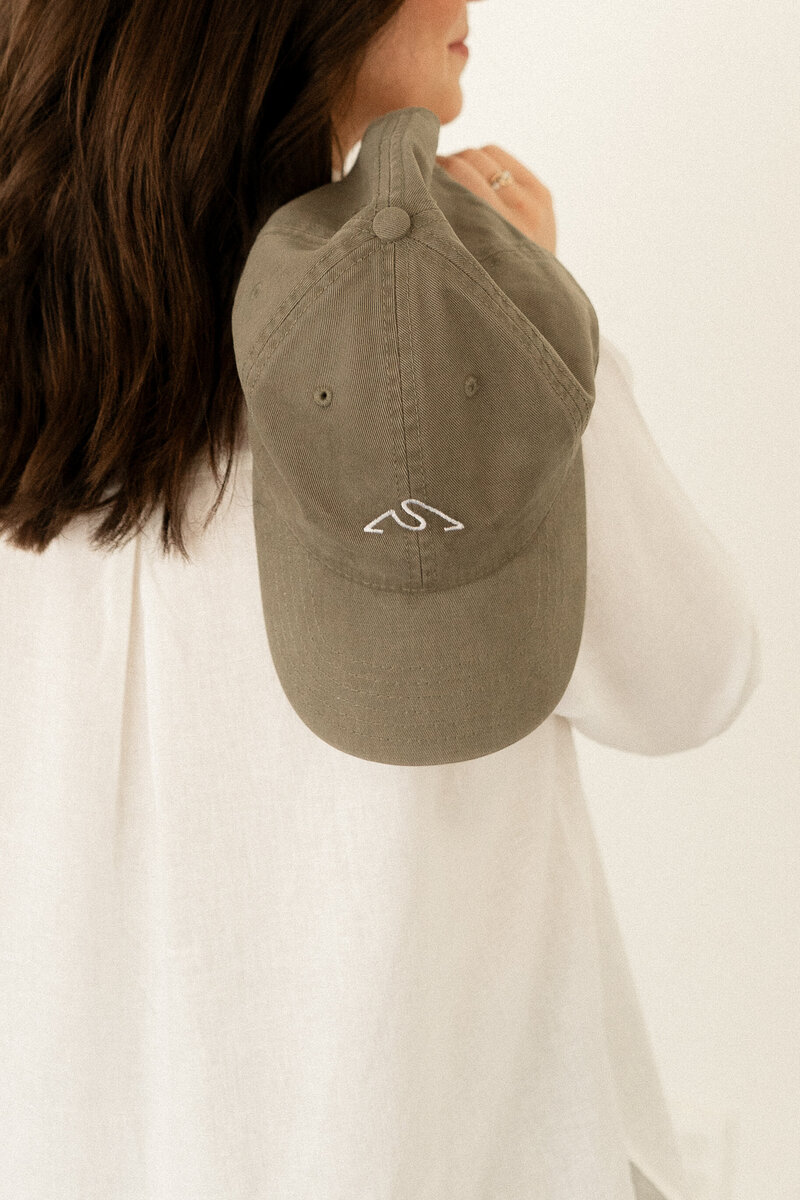 Olive green hat with custom nature inspired logo mark