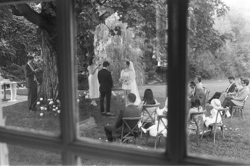 Two woman walking to their wedding reception among friends and family