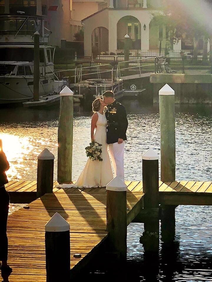 Couple kisses on Dock at Palafox Wharf in Pensacola FL