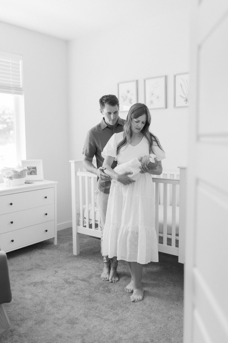 Newborn photography Salt Lake City session with a baby resting in a white, light-filled nursery.