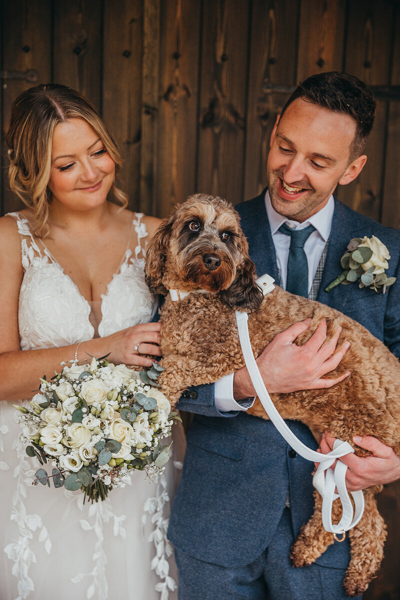 newlywed couple pose with their dog