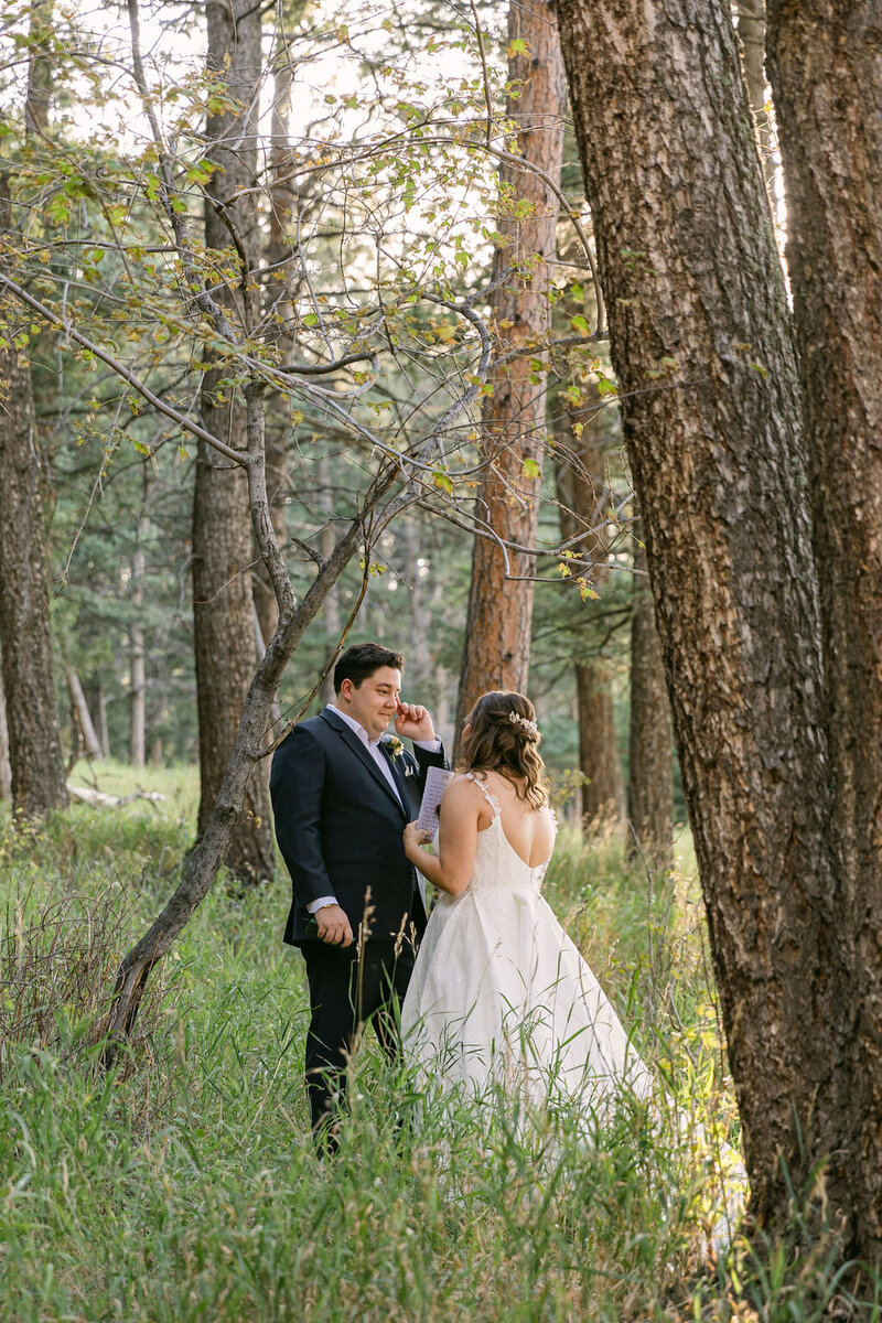 intimate first look between bride and groom at colorado wedding venue The Pines by wedgewood weddings