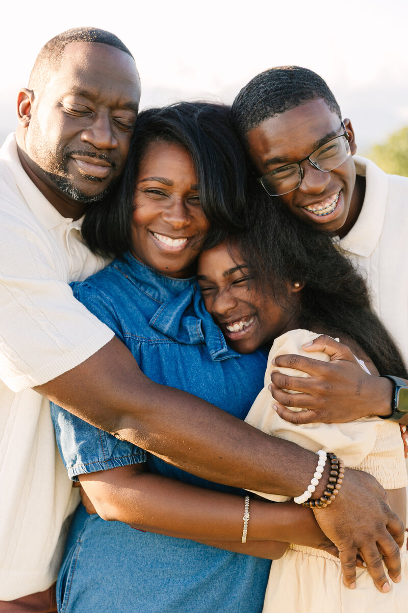 Family hug at Black Balsam Knob in Hendersonville, NC with Asheville Family Photographer Rachel Marie Photography