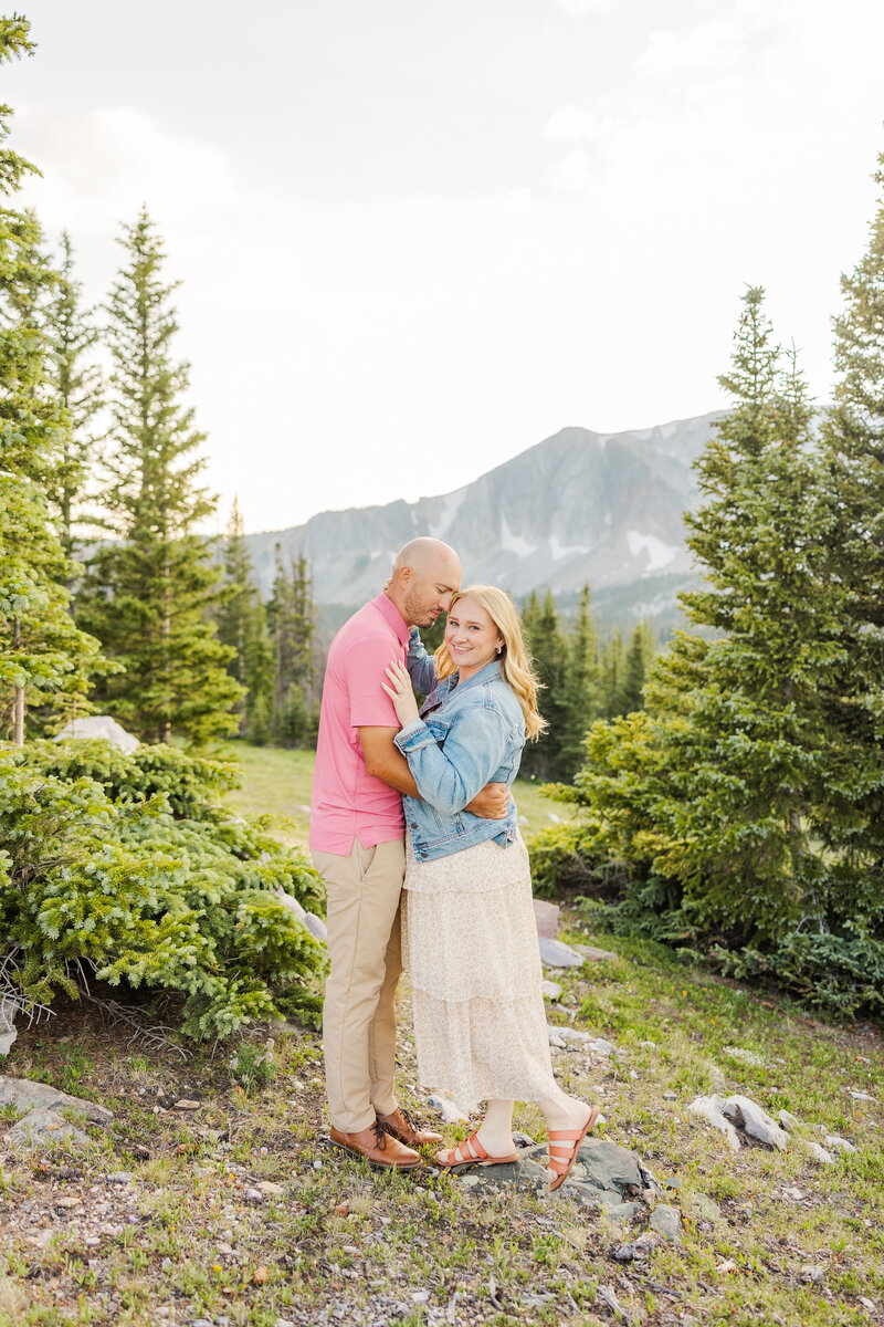 Couple posing together at their engagement session in the Snowy Range Mountains at Sugarloaf near Laramie, Wyoming