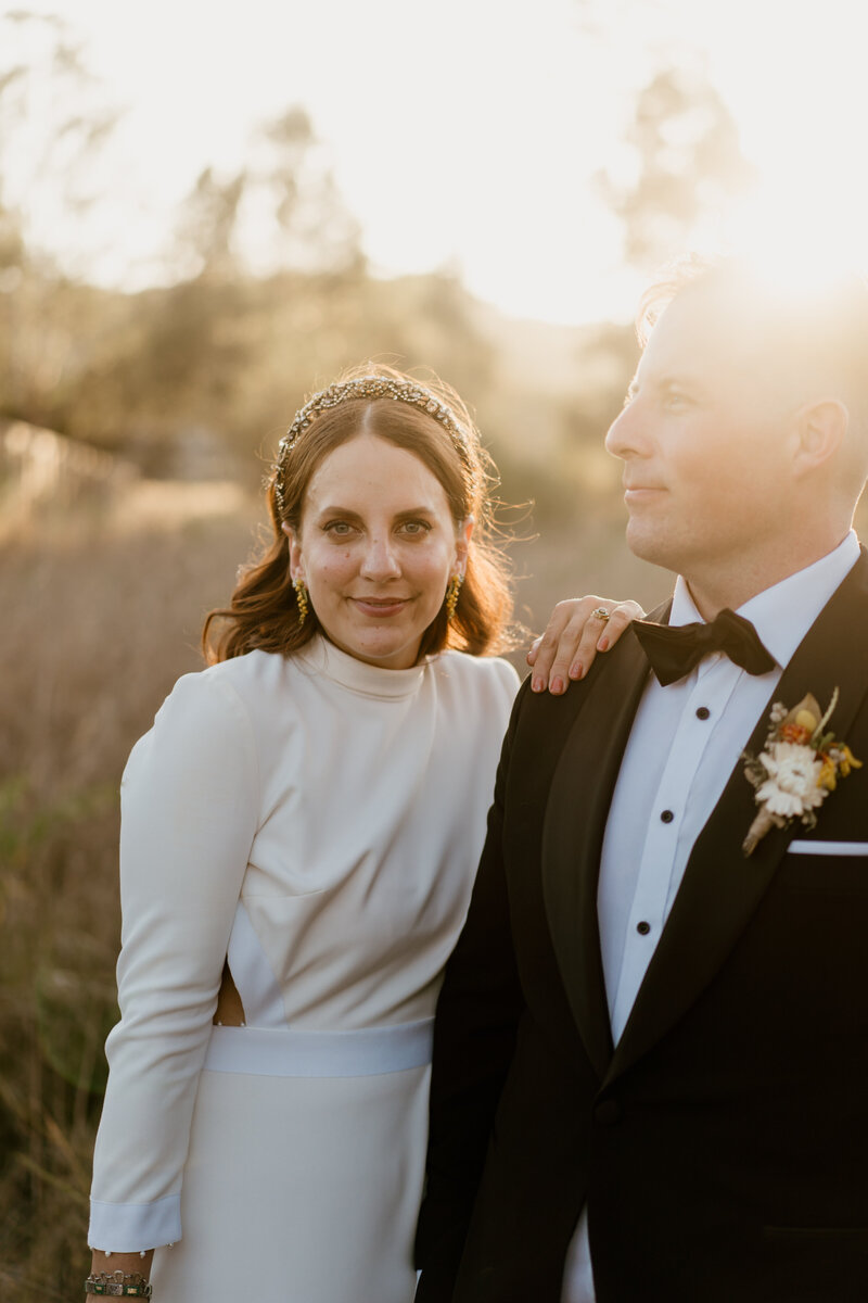 Groom kissing bride on the cheek at Albert River Wines - Mt Tamborine wedding