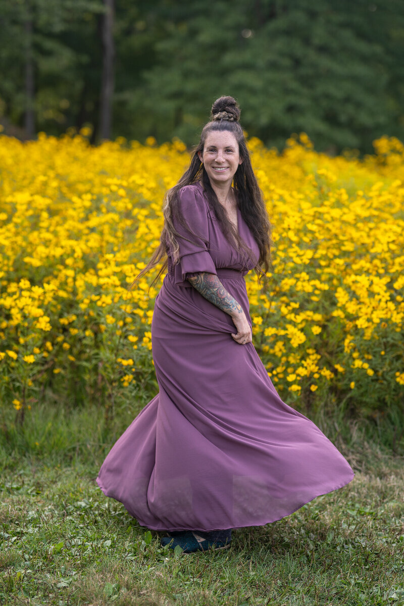 girl twirling in dress in yellow flower field in bay village ohio