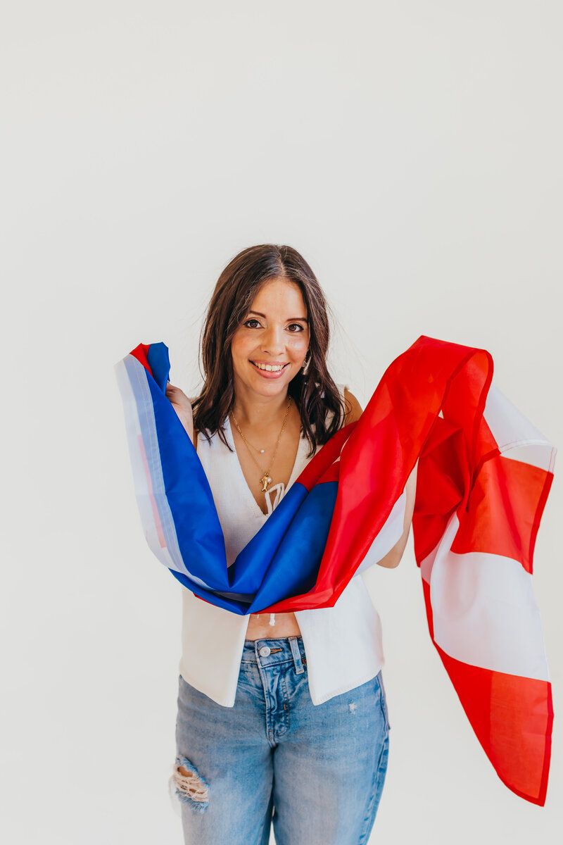 Smiling wide while holding the Puerto Rican flag in my hands, radiating pride and joy. A moment full of love for my roots and culture.