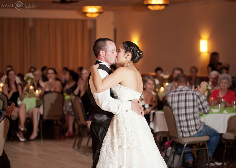Couple kisses during first dance at Silverthorne Pavilion in Colorado