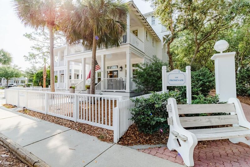 white two story home with bench