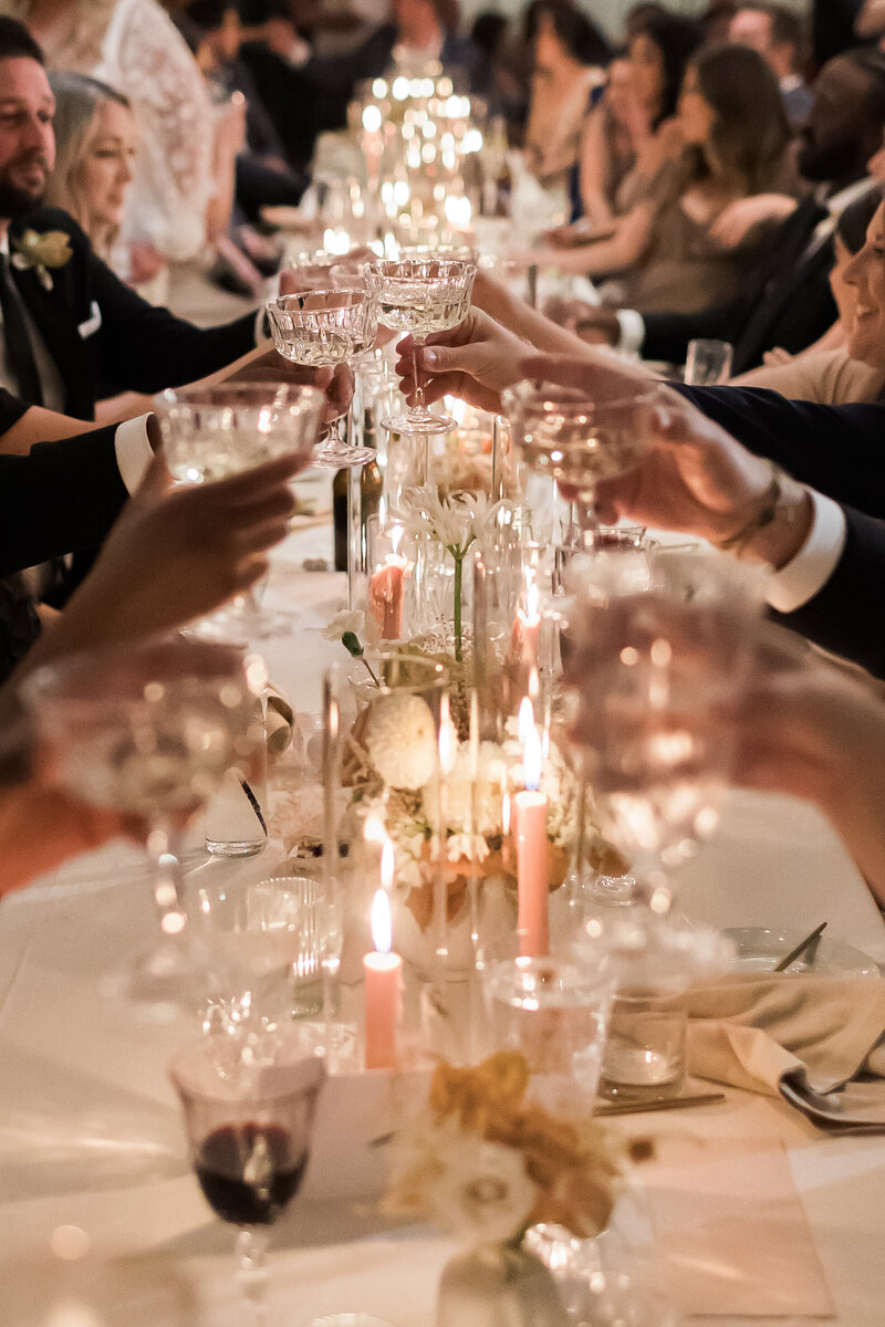 Wedding guests clink glasses during wedding toast