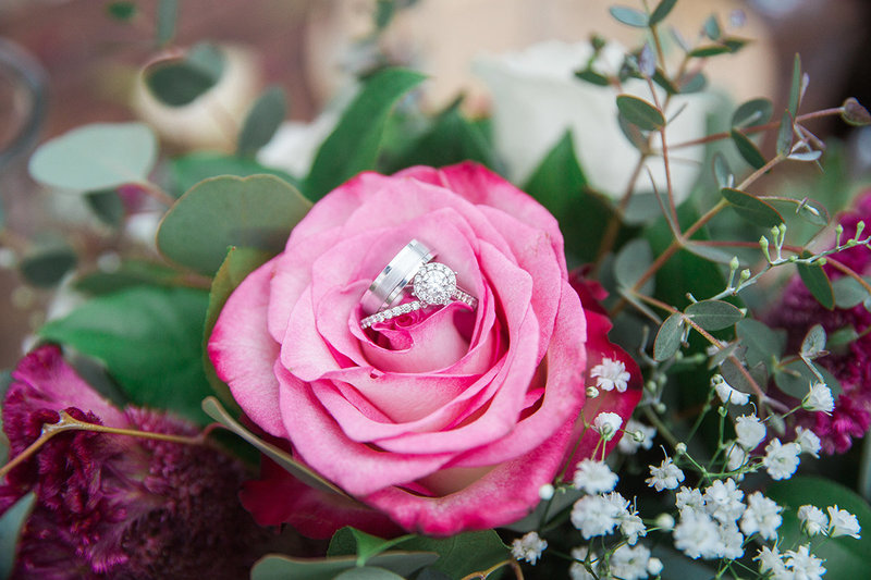 photo of rings on rose at redondo beach hotel wedding
