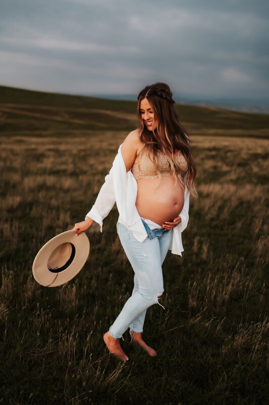 Pregnant mother in a parka holding her belly .