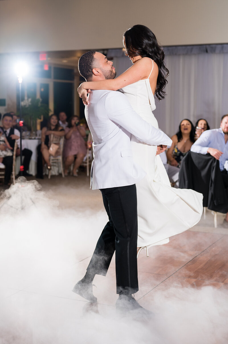 Bride and groom’s first dance under chandeliers at Emerald at Queensridge ballroom.