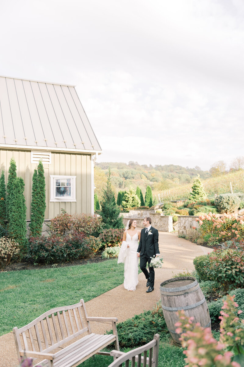 Couple walking up path during wedding day at winery in VA