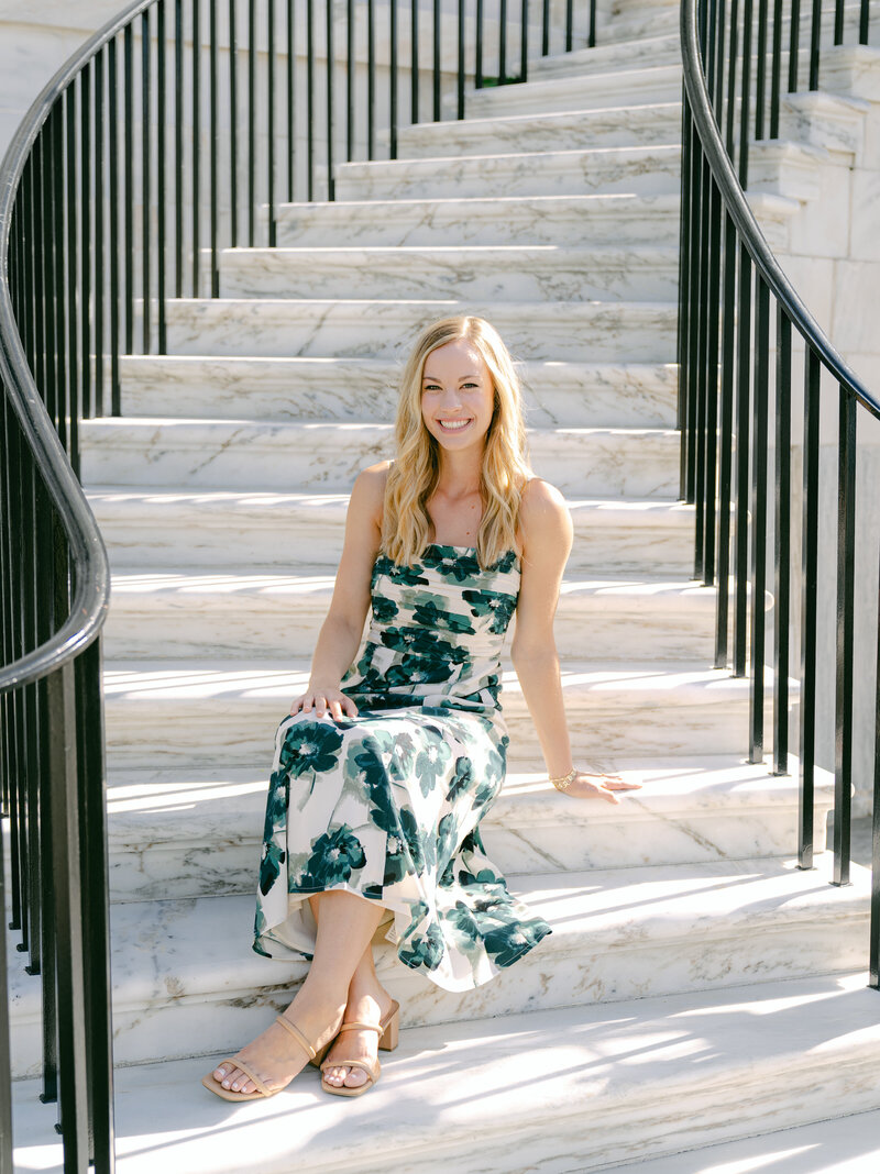 headshot of Laura smiling in a blue dress