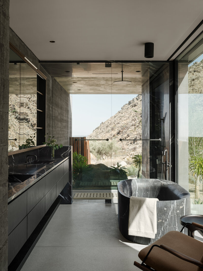 Modern kitchen with marble counters and wood cabinets designed by Palm Springs architect.