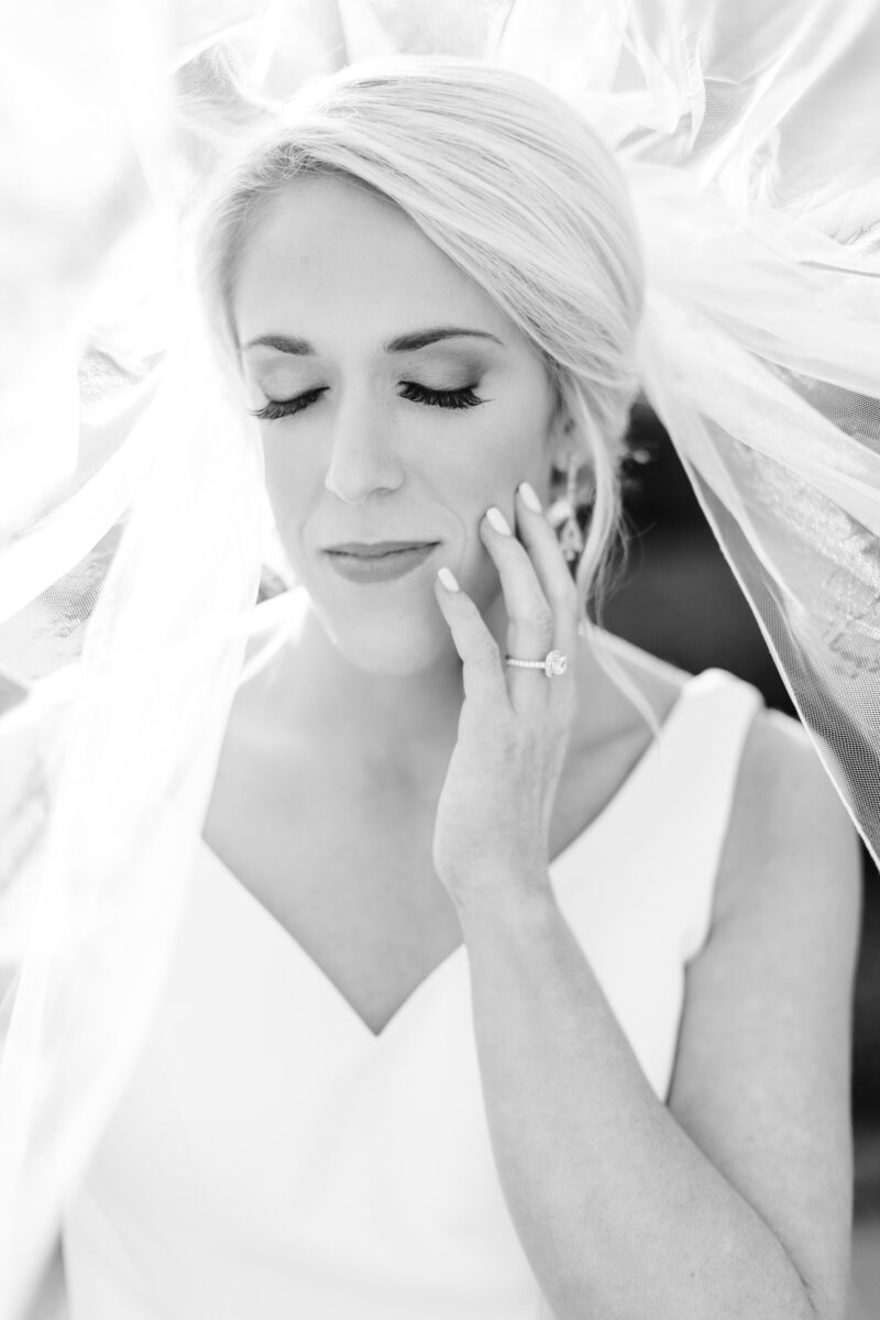 bride touching face with eyes closed