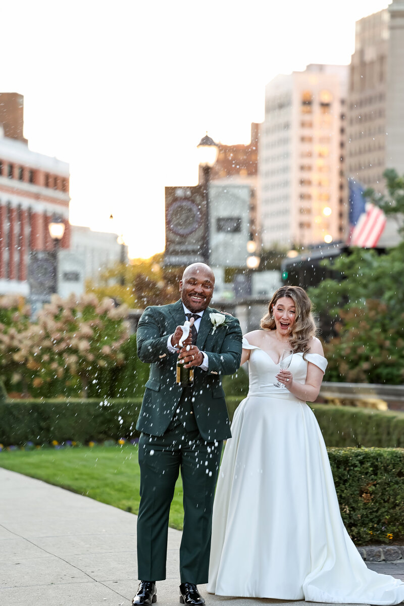 Detroit wedding photographer. Couple doing a toast downtown Detroit.