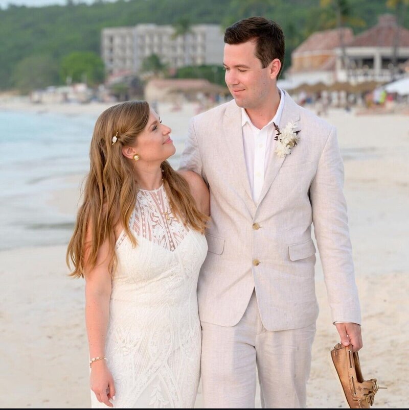 Couple walking on the beach after destination wedding by travel planner CC Vacations