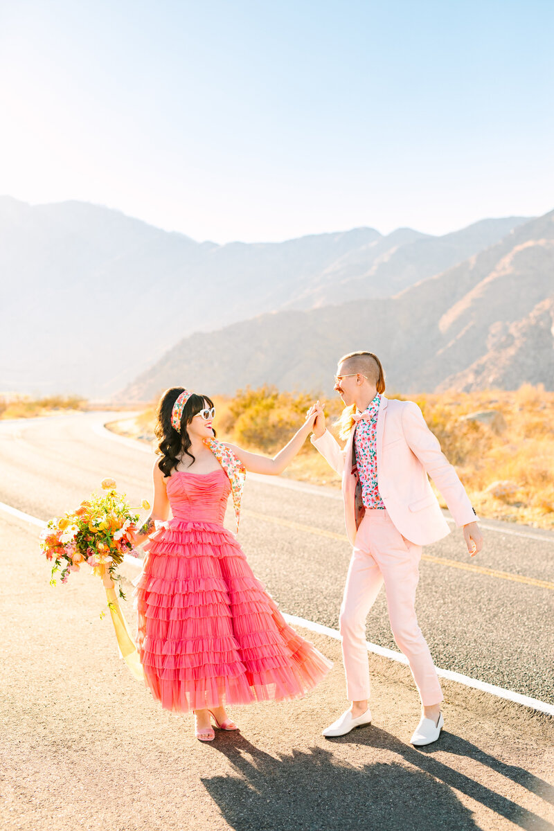 vintage dress couple dancing alongside a road in california