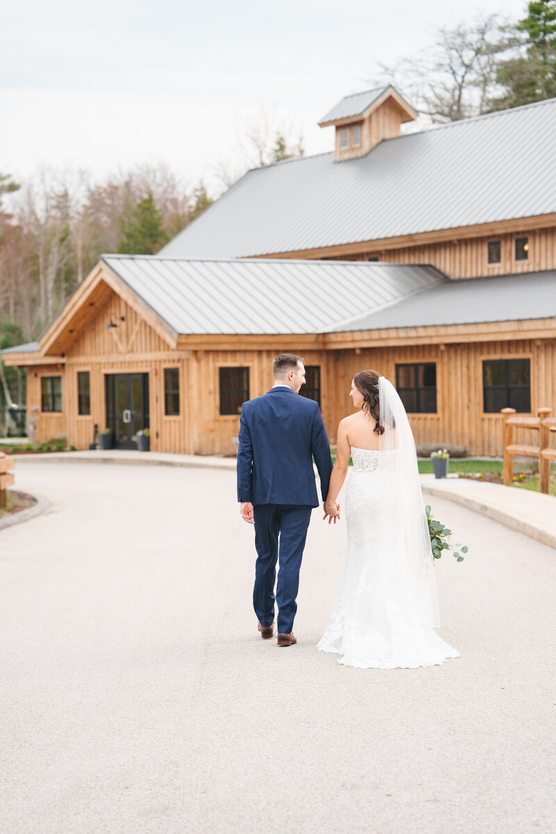 Barn at Bull Meadow, couple walking together after ceremony