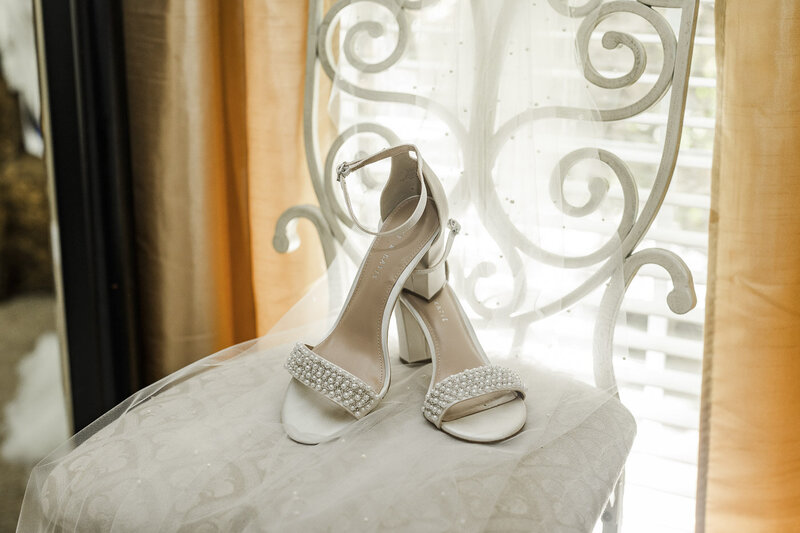 Pair of high heels gently stacked on an elegant chair