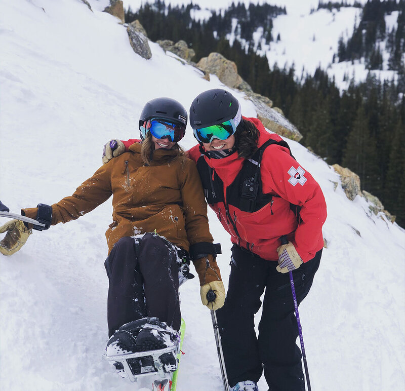 Beth Requist, custom web designer, beth and a ski patroller on a mountain skiing
