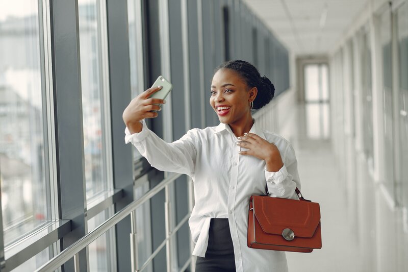 Woman taking professional office selfie