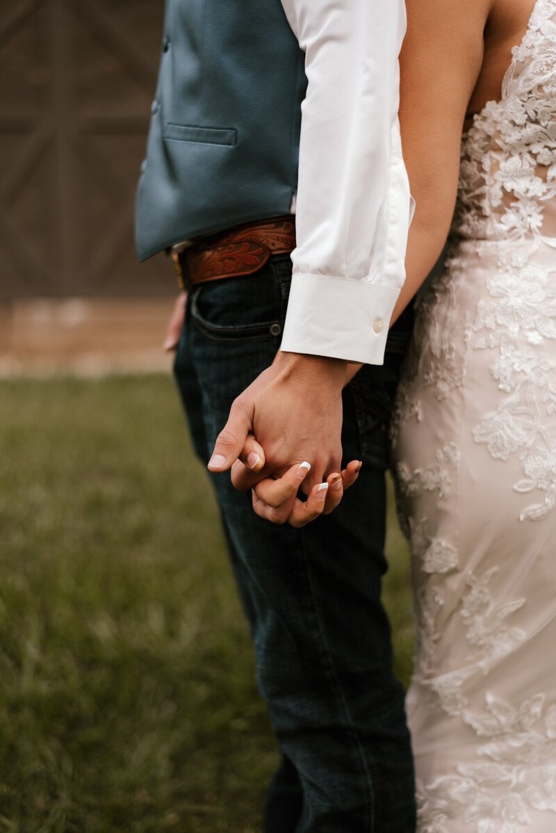 bride and groom hold hands after wedding in peoria il
