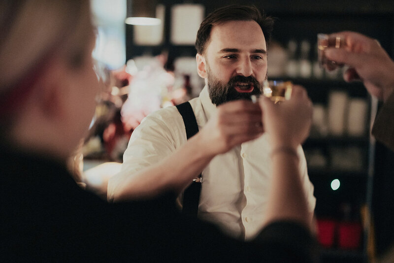 Friends and family enjoying dinner during wedding reception at Mott Street restaurant in Chicago, photographed by Bradi Potter