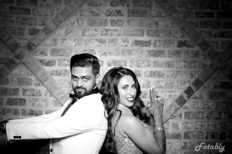 bride and groom posing for vintage photo booth in Houston