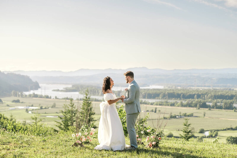 Bride and groom at a scenic outdoor elopement, representing the documentary wedding photography style of Among the Oaks. 