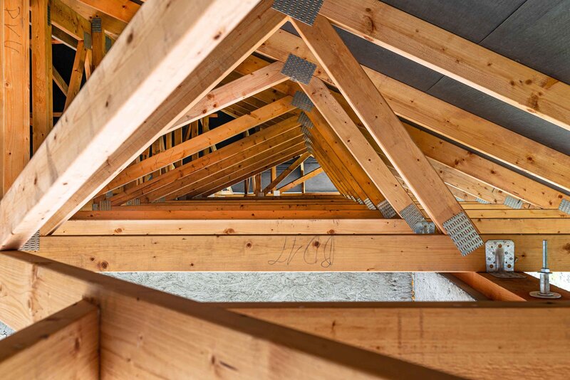 Covered roof trusses on a house under construction.